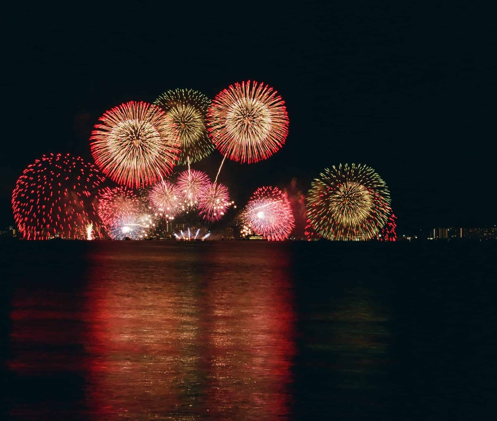 fireworks above water and skyline