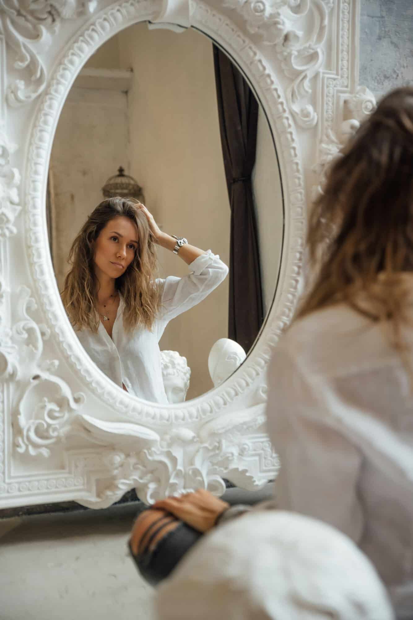 a woman looking into a mirror